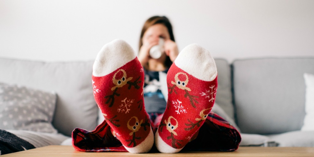 Woman Drinking out of mug with Reindeer Socks on