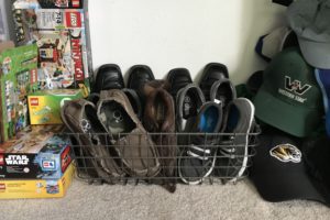 kids' dress shoes in a wire basket in closet