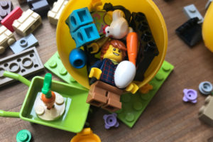 Lego guy, chicken, easter egg and various lego pieces in an easter egg