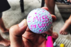 Golf ball with "I miss my wife" written on it
