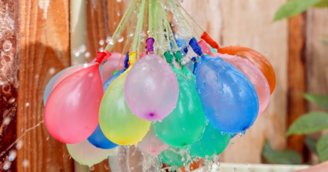 water balloons hanging in front of wooden fence sm 20a