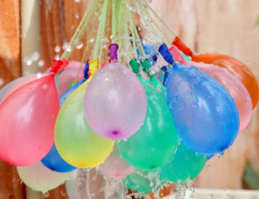 water balloons hanging in front of wooden fence sm 20a