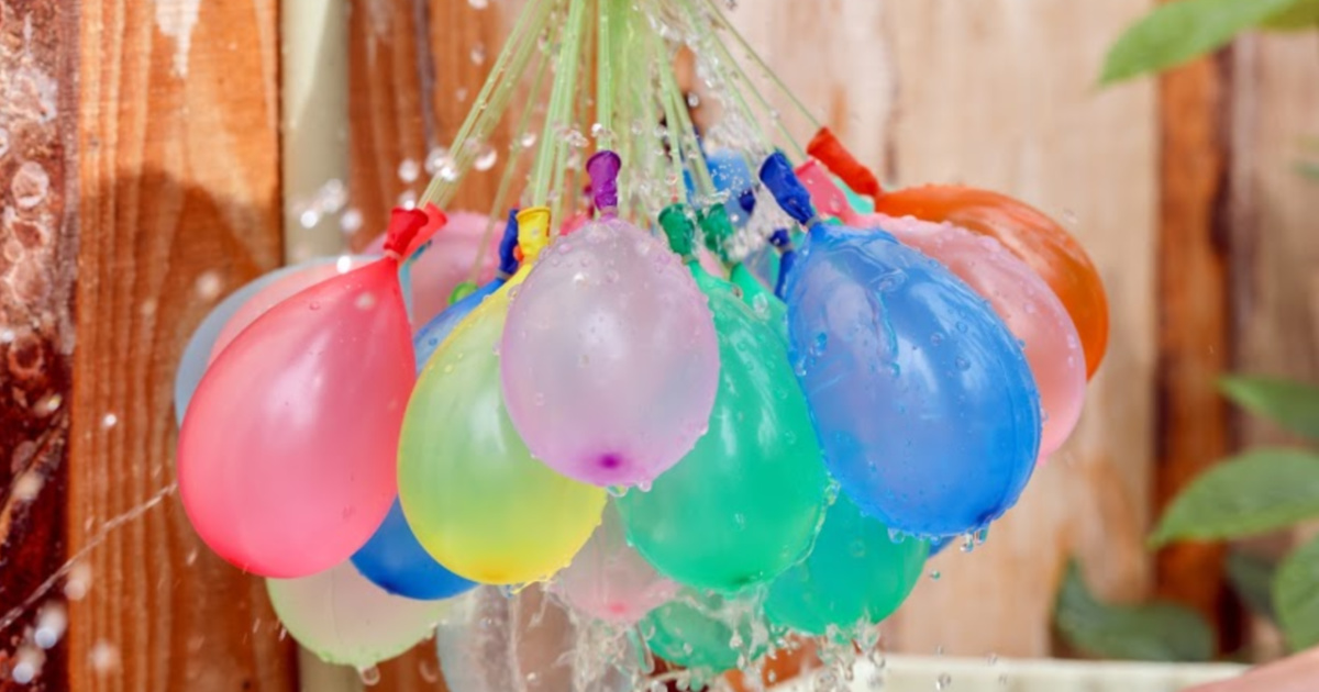 water balloons hanging in front of wooden fence sm 20a.